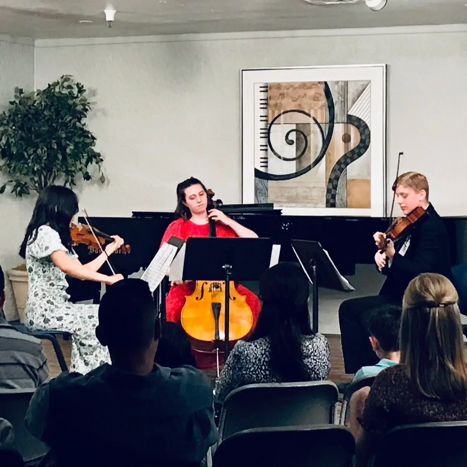Young student performing solo on stage under spotlights
