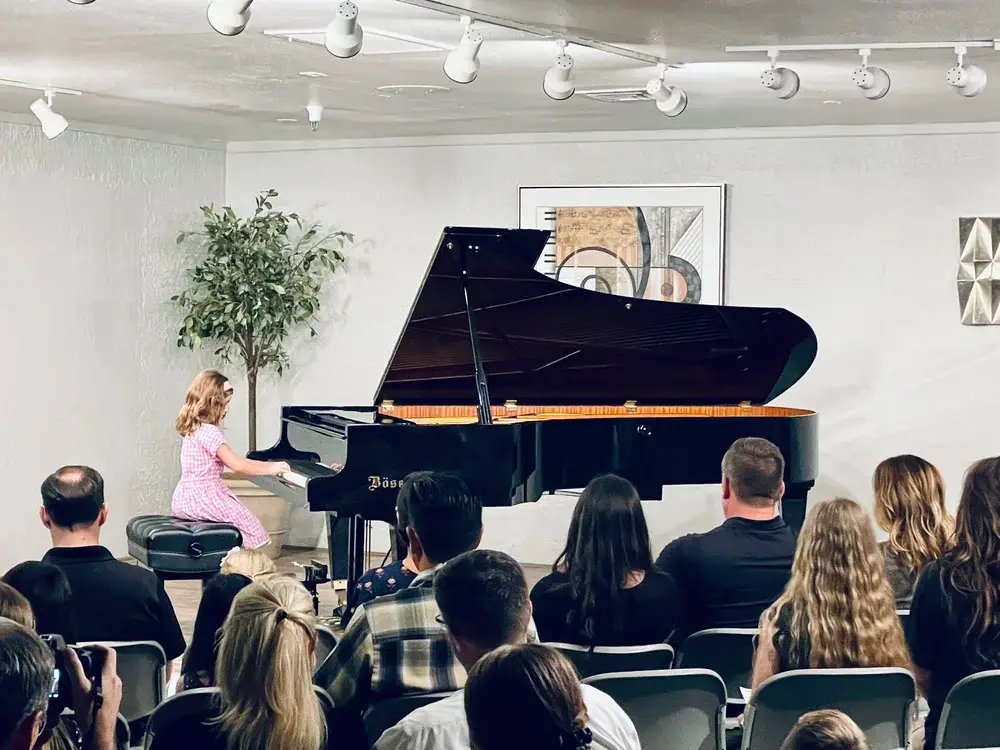 Music instructor working with students in a school setting